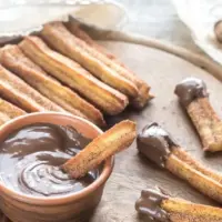 baked churros served with chocolate