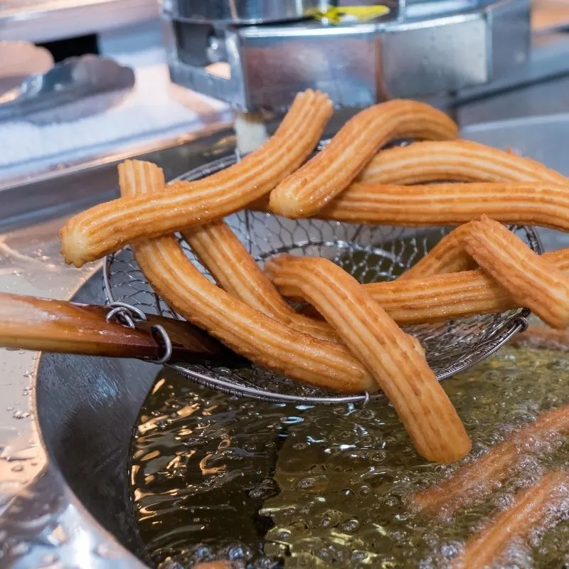 Homemade Churros being fried in oil