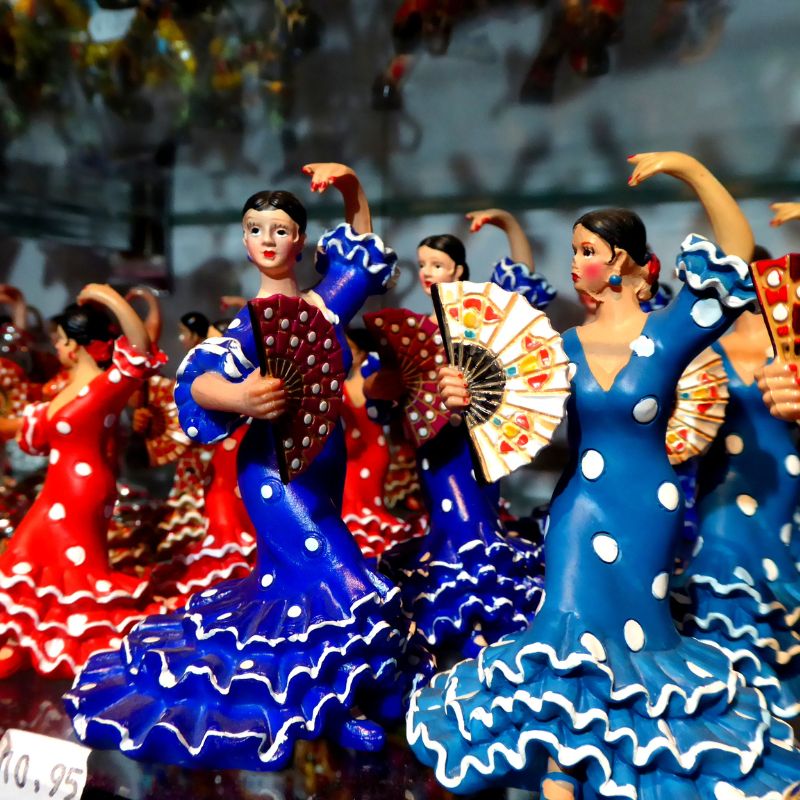 figurines of flamenco dancers that is for sale on a shop