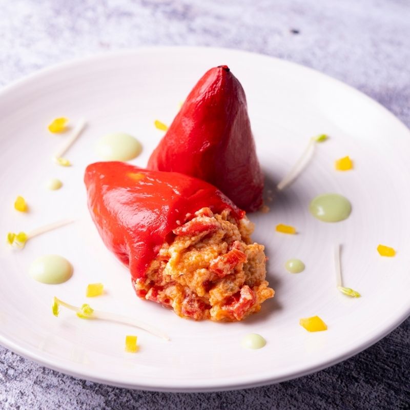 spanish stuffed peppers on a white plate.