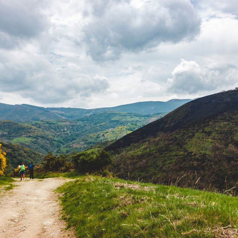 Camino de Santiago, two women hiking towards a mountain