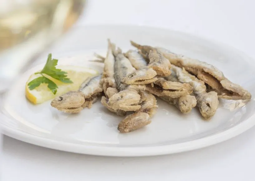 Restaurante Eslava, a closeup of small fish on a plate on a table