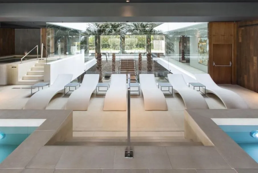 trees, pool chairs on a big room at The Oasis by Don Carlos Resort