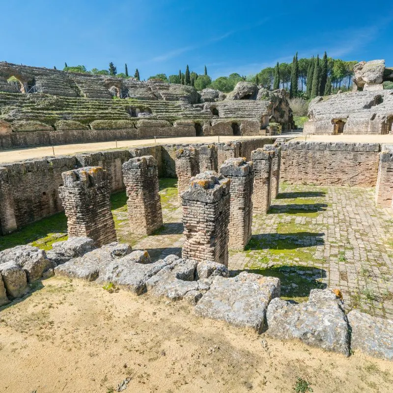 Pre-Roman city of Italica, roman ruins amidst a blue sky