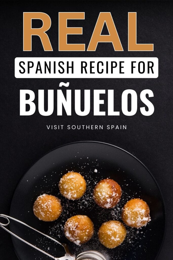 A top photo of a group of bunuelos on a plate and it has powdered sugar on them. There is a tool beside them.