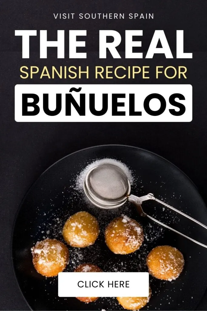 A top photo of a group of bunuelos on a plate and it has powdered sugar on them. There is a tool beside them with sugar.