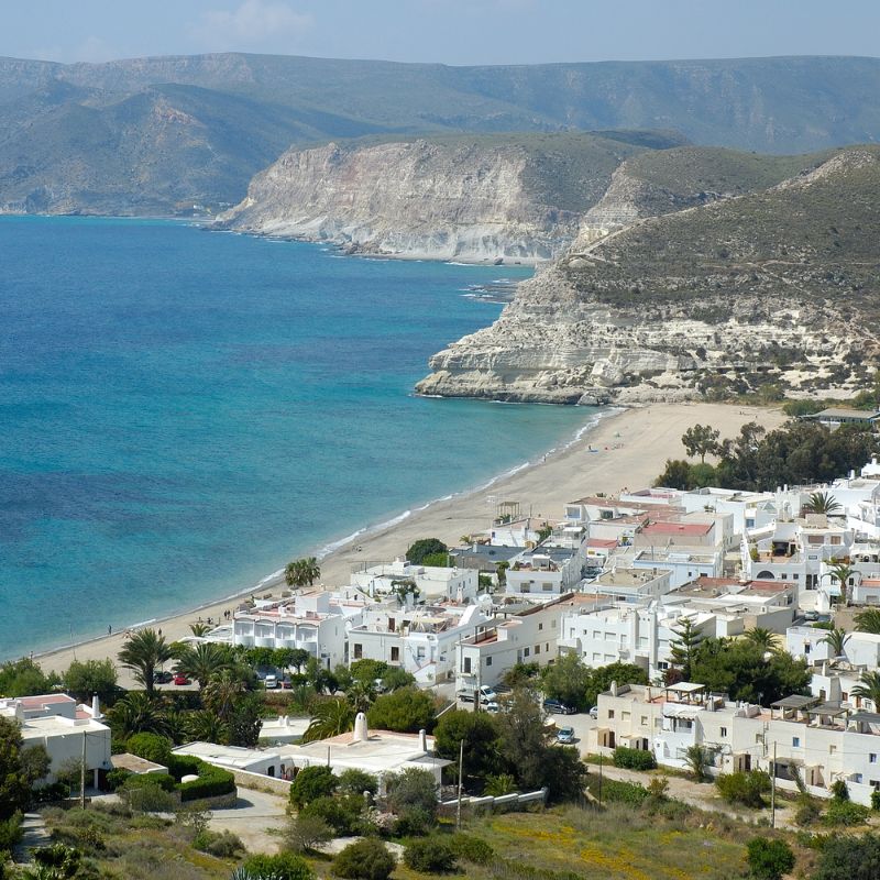 aerial view of Almeria filled with white houses by the beach and mountains