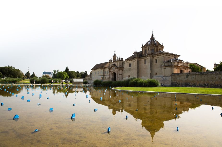 Andalusian Museum of Contemporary Art from a body of water with blue pieces sticking out