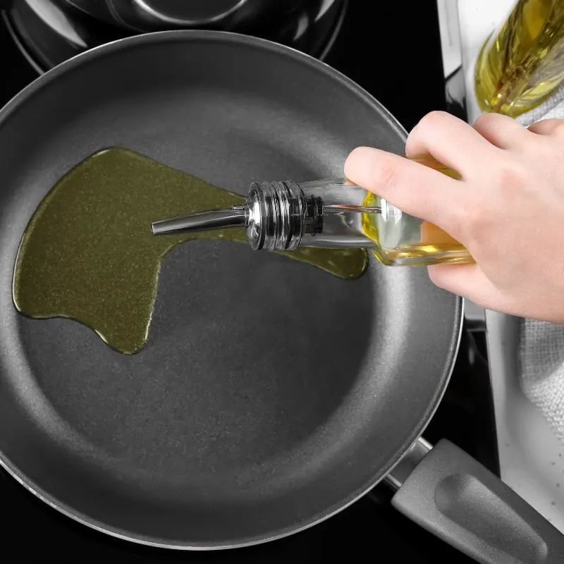 pan with oil for frying on a stove for preparing spanish rice with beef.