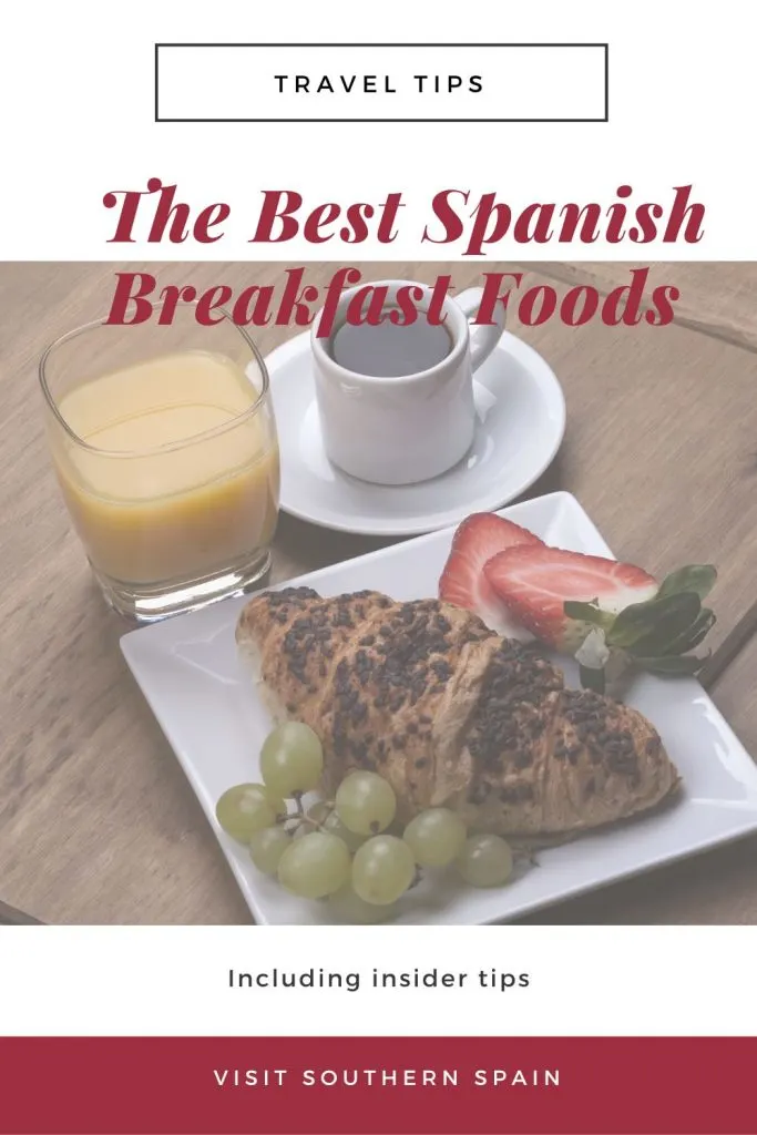 A plate with a spanish pastry, grapes and strawberries, next to coffee and orange juice on a white plate, on wooden table. On to it's written the best spanish breakfast foods.
