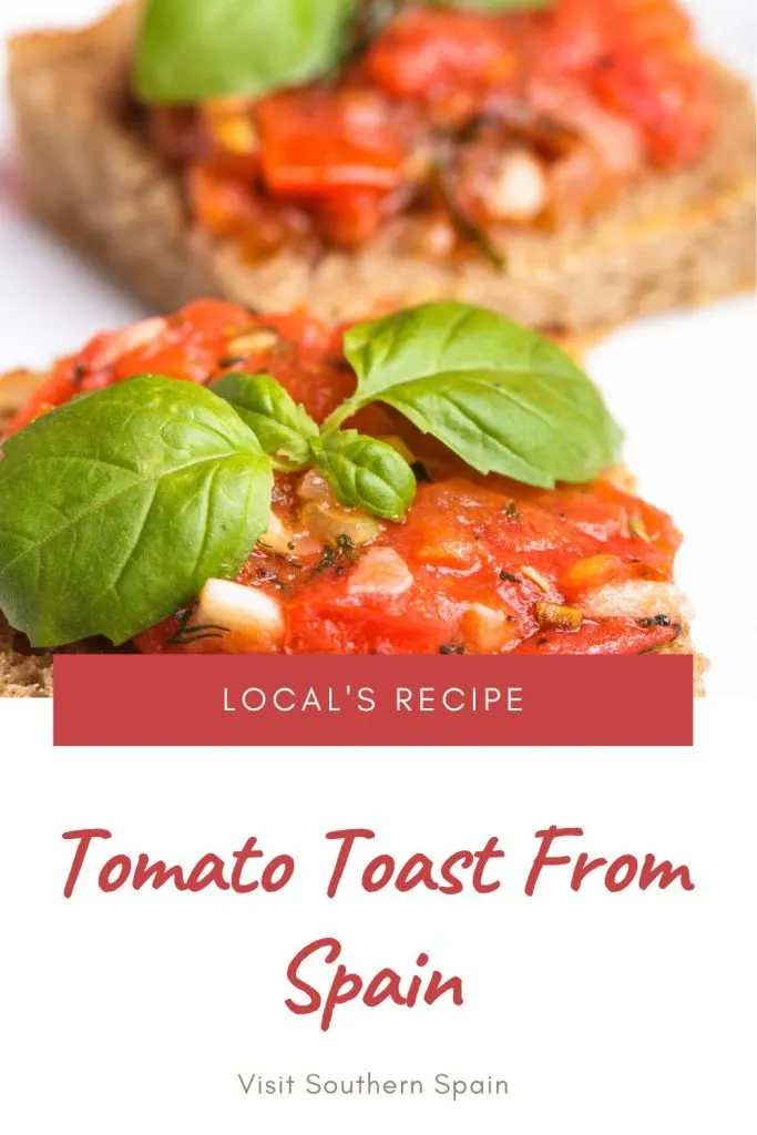 Closeup with a spanish tomato toast decorated with basil leaf. Written under it is Tomato Toast from Spain