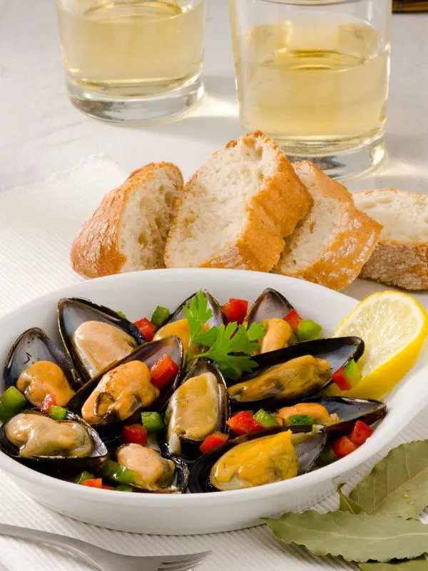 spanish clams in a white bowl next to some fresh bread. 25 Best Spanish Seafood Recipes to Try at Once!