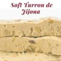 A closeup with 3 bars of soft turron stacked on top of each other.
