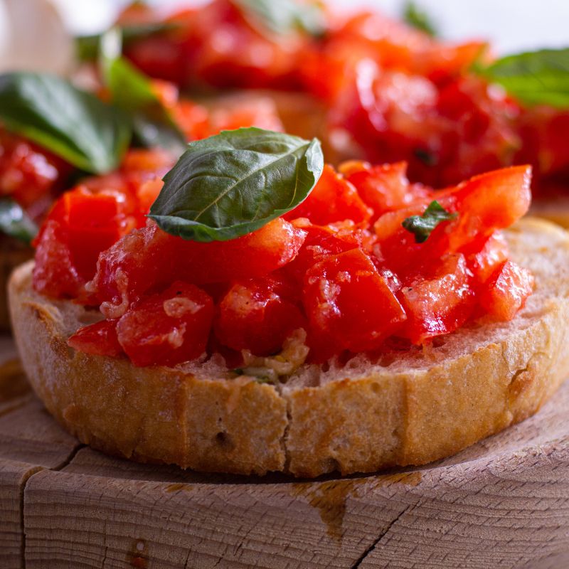 spanish toast with tomato on a wooden plate.