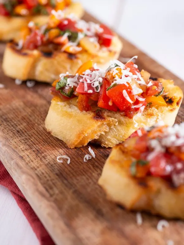 tomato toast served on a wooden table.