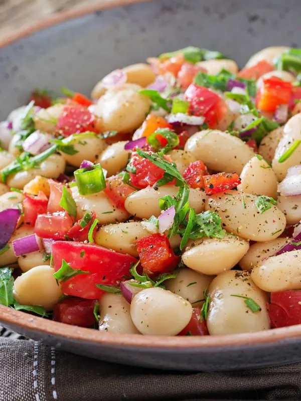 a closeup of a white bean salad on a plate