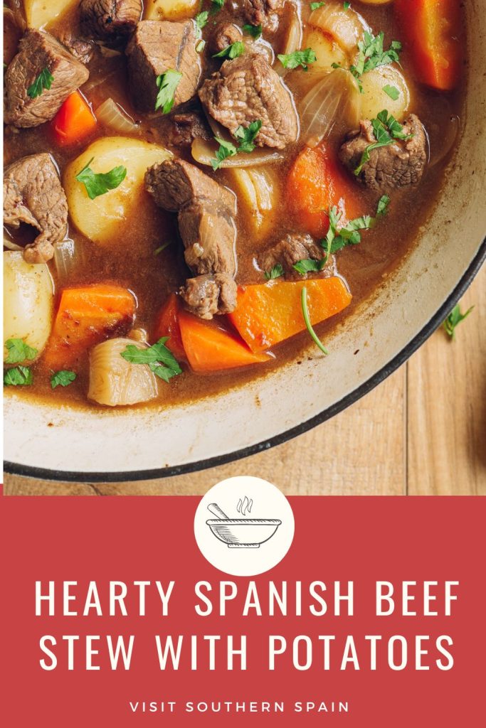 closeup with a bowl of beef stew on a wooden table. Under it it's written hearty Spanish beef stew with potatoes.