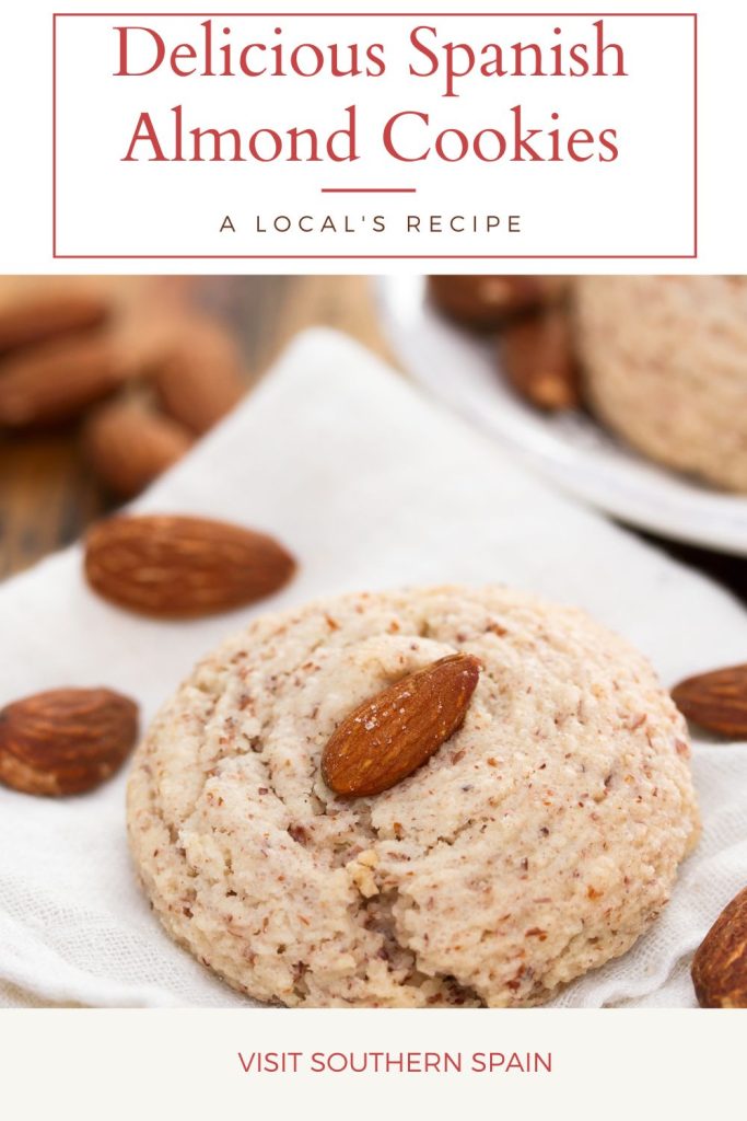 Closeup with an almond cookies on a white plate. On top it's written Delicious Spanish almond cookies.