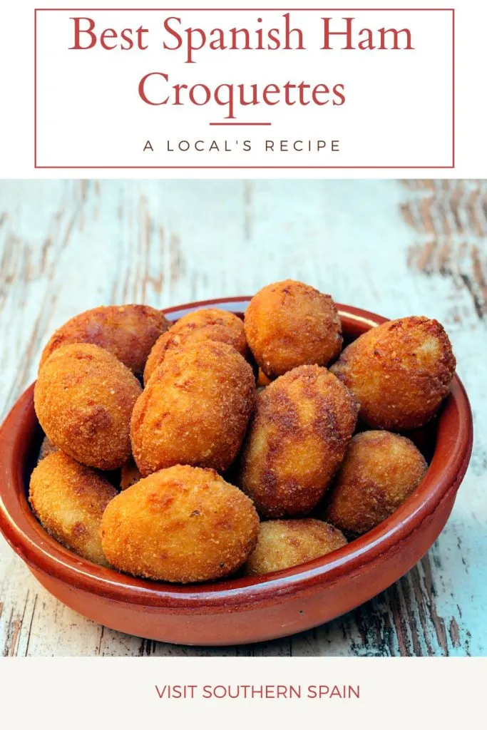 Ham croquettes in a clay bowl, on a wooden table. On top it's written Best Spanish ham croquettes.
