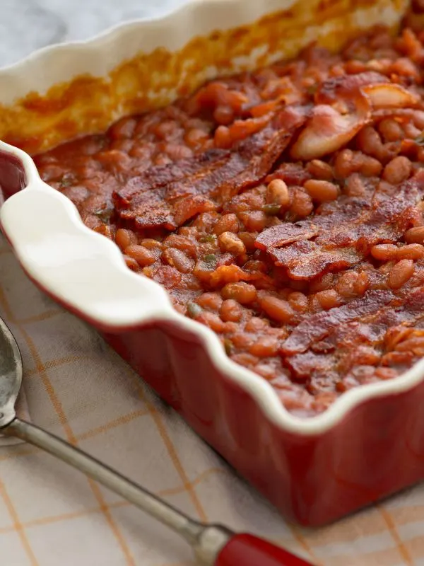 Spanish beans recipe in a pan with bacon.