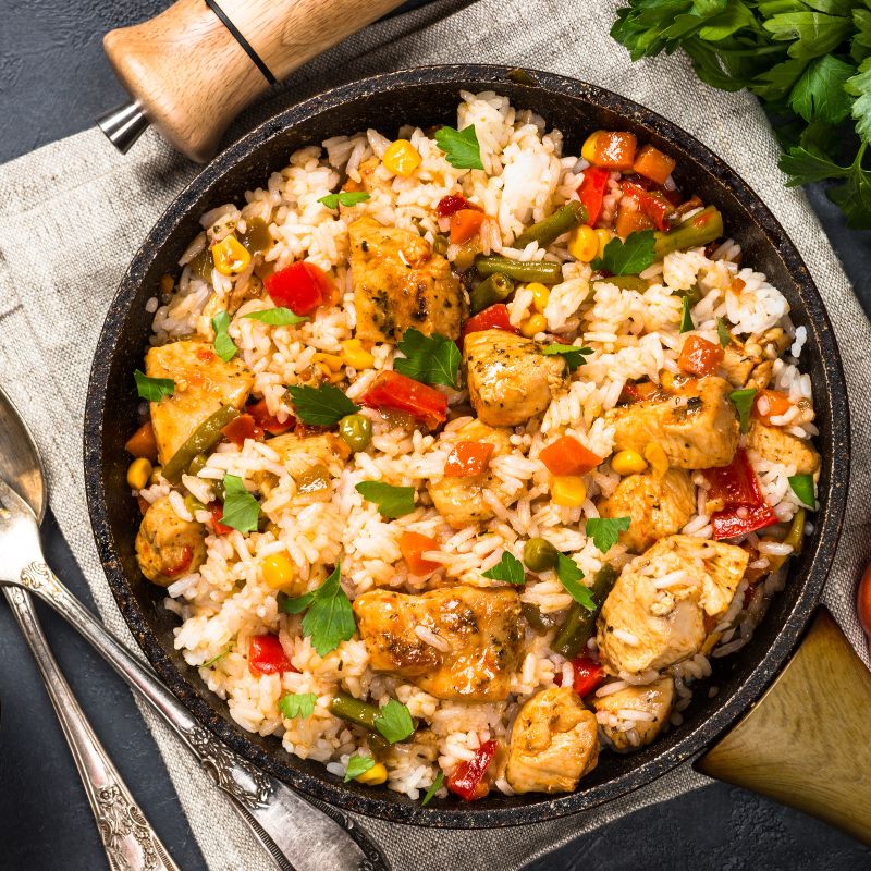 Spanish chicken and rice in a pot on a tablecloth. Easy Spanish Chicken and Rice Recipe