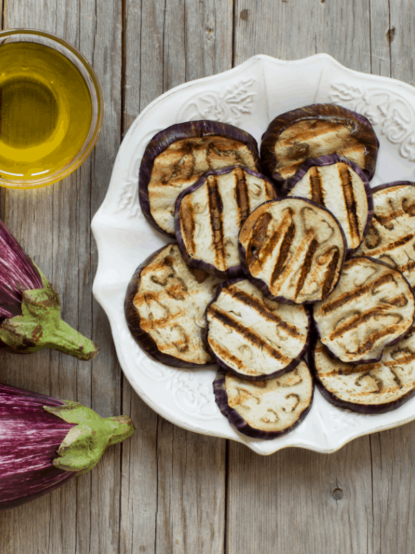 berenjenas fritas con miel, fried eggplants on a white plate with wooden background. 20 Best Spanish Vegetarian Tapas You Will Love