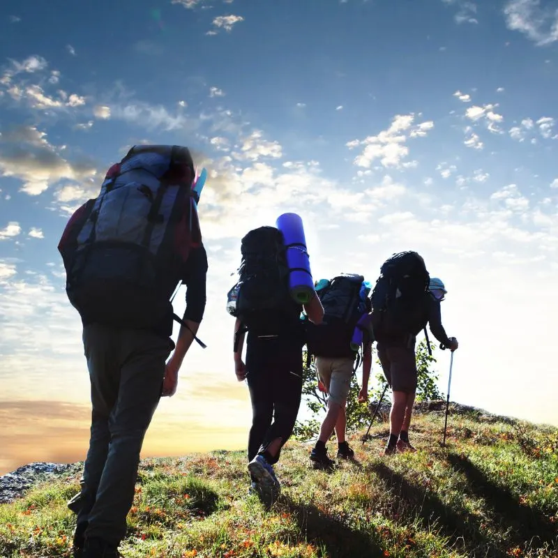 a group of people with backpacks hiking on a trail. 20 Best Hikes in Andalucia for Every Level