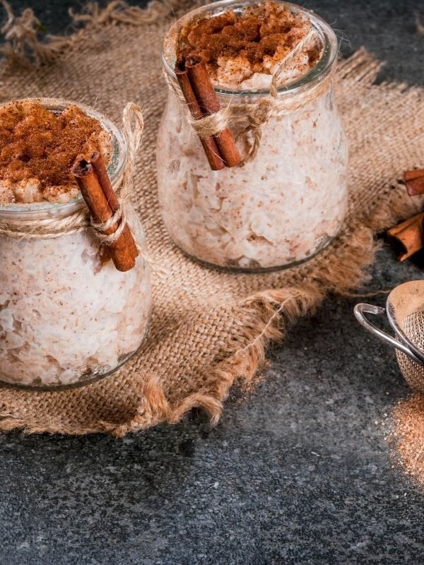 arroz con leche in 2 jars with cinnamon 