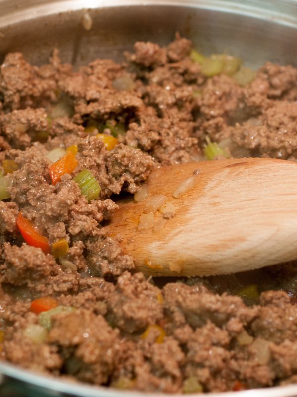 closeup with spanish rice with beef cooking in a pan.