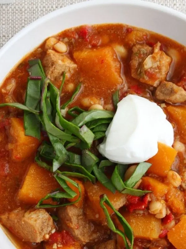 Spanish Pork Stew in a white bowl. 25 Ideas for the Best Spanish Themed Party 