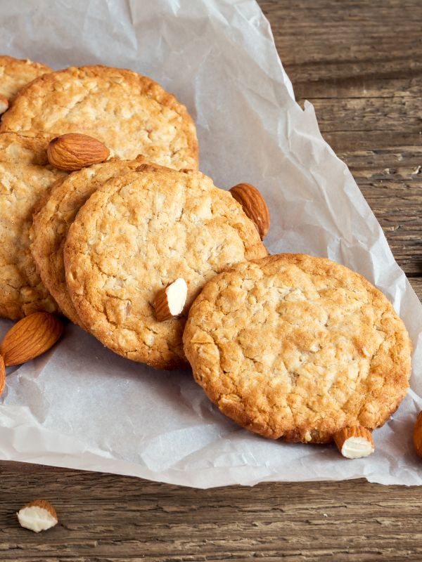 spanish almond cookies on parchment, on a wooden table.