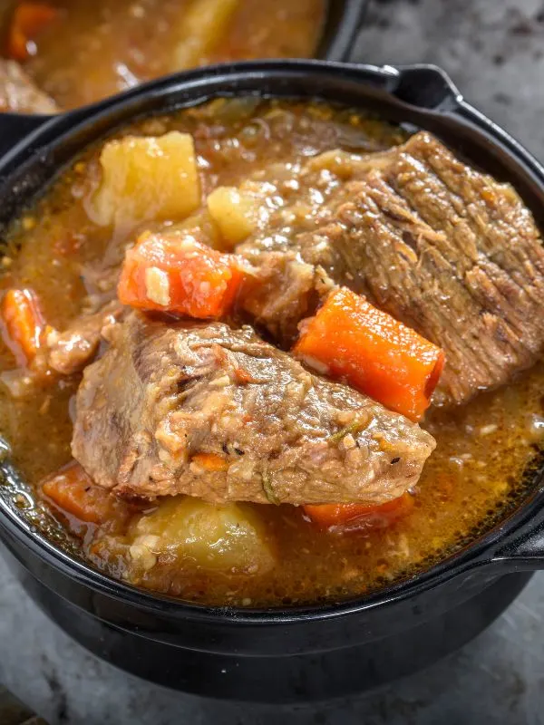 spanish beef stew with potatoes in a serving bowl