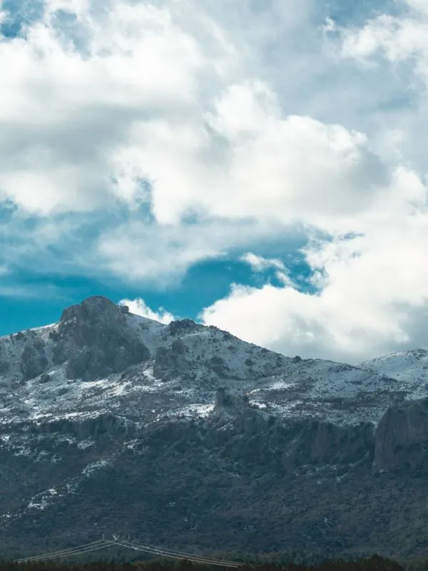 views of Sierra Nevada mountain in Granada with snowy top and cloudy bright skies, Andalucia in August