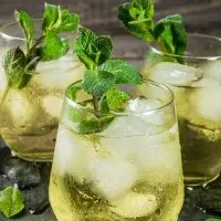 3 glasses of rebujito, a spanish cocktail with sherry wine and lemon soda topped with mint leaves