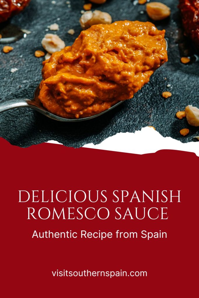 romesco sauce in a spoon on a black table. Under it it's written Delicious Spanish romesco sauce. 