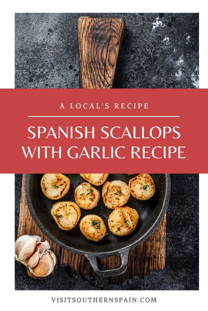a pot with garlic scallops on a wooden table with garlic next to it. In the middle it's written Spanish scallops with garlic recipe.