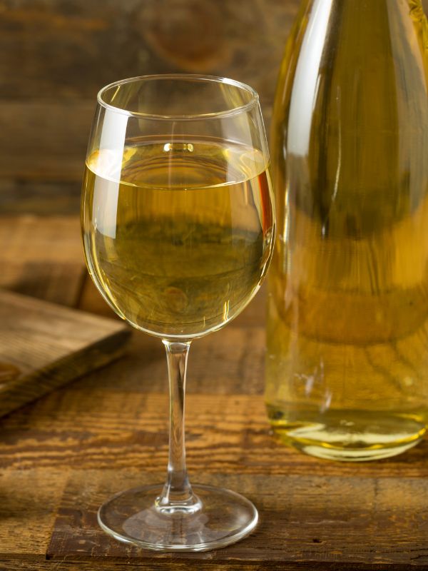 Albariño white wine in a glass with a bottle of wine in the background. 30 Most Famous Spanish Drinks