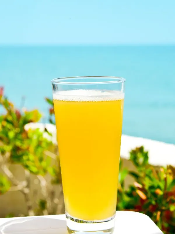 Clara Beer, a Spanish drink made with beer and lemonade on a glass with the beach on the background