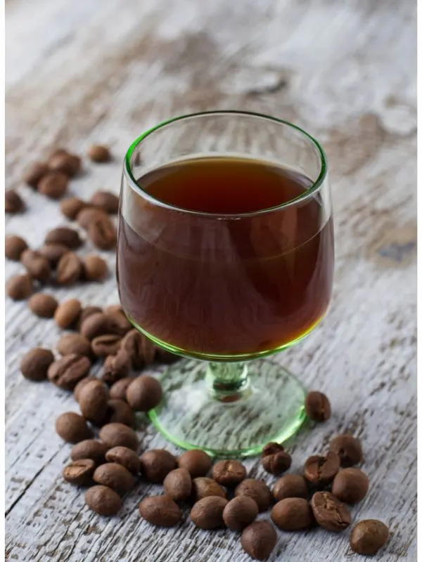 Resoli, a Spanish coffee liquor in a glass with coffee beans next to it. 30 Most Famous Spanish Drinks