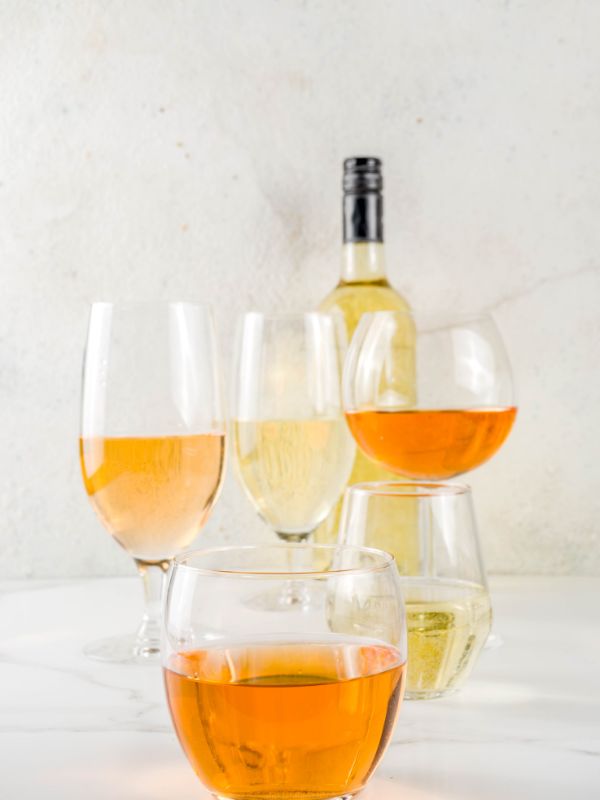 Spanish orange wine in various glasses with a bottle in the back. 20 Best Spanish Souvenirs from Andalucia