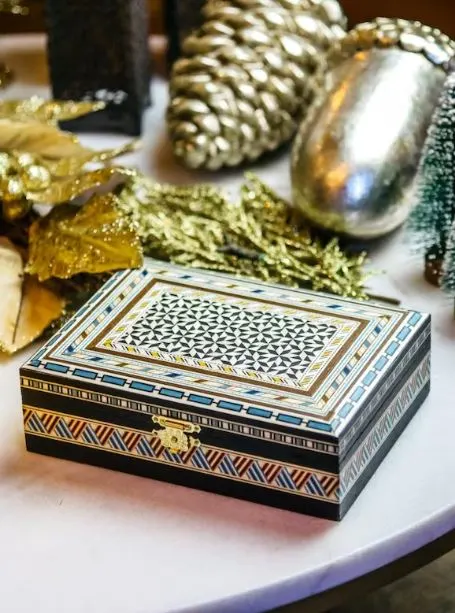 a taracea box with Spanish design on a Christmas decorated table. 20 Best Spanish Souvenirs from Andalucia