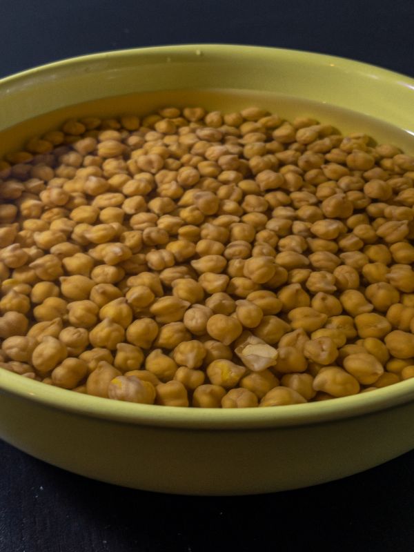 chickpeas soaking in a bowl with water for the spanish chickpea soup
