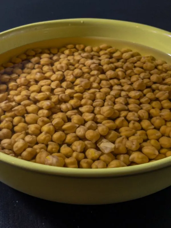 chickpeas soaking in a bowl with water for the Garbanzo Bean Soup With Ham