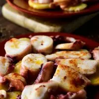 closeup with Spanish octopus recipe on a clay plate
