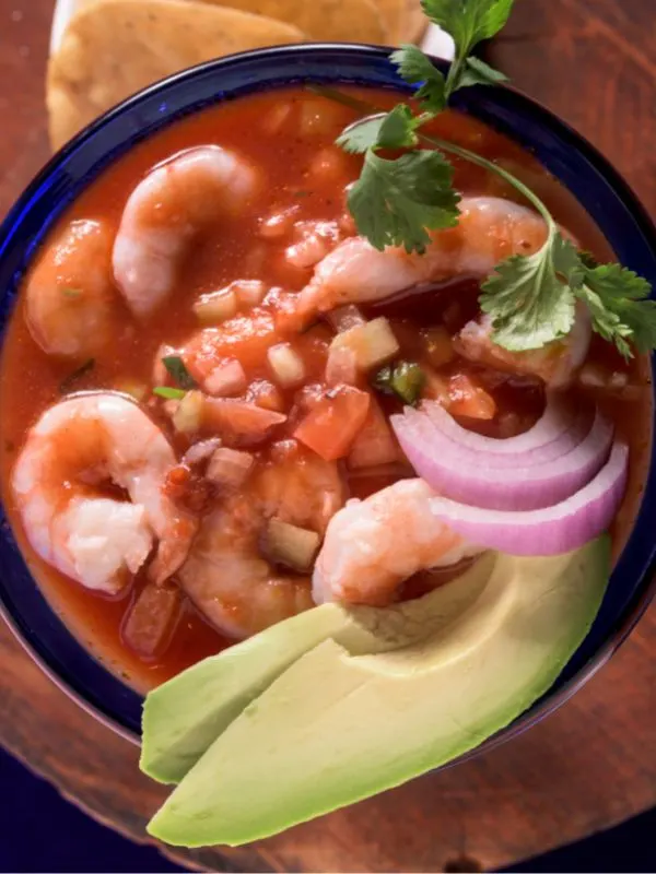 closeup with Spanish shrimp cocktail made with red sauce, shrimps and avocado.