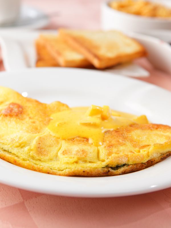 closeup with Spanish cheese omelet on a white plate.