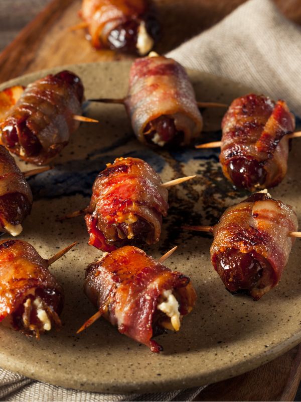 dates wrapped in bacon a serving plate