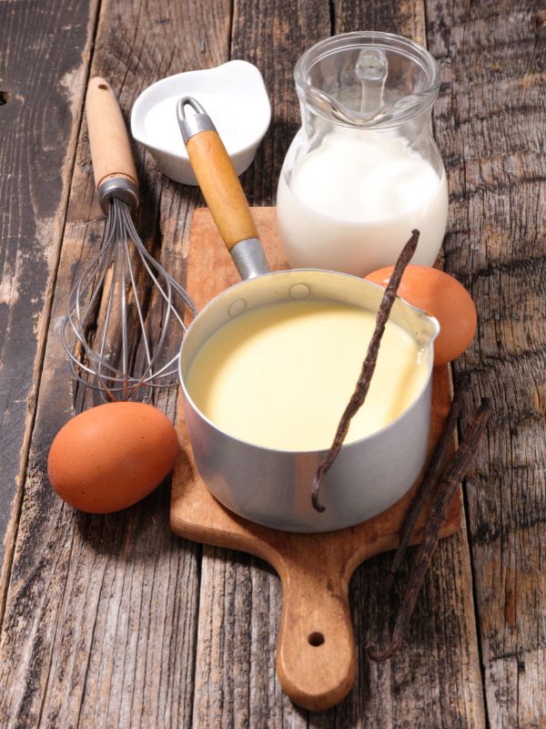ingredients such as eggs, milk, sugar and natillas de leche in a pot