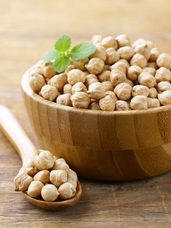 raw chickpeas in a wooden bowl.