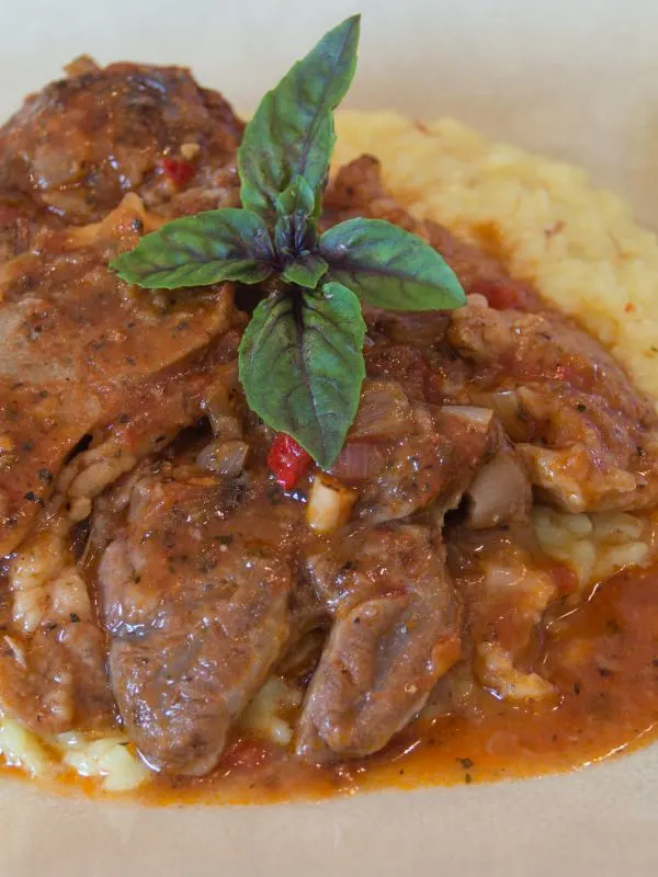 spanish osso buco served with mashed potatoes.